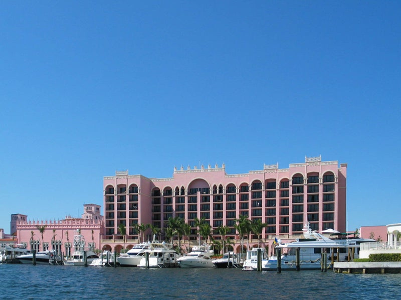 Pink hotel with a marina with boats